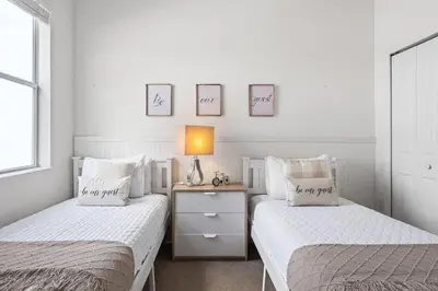two beds in a bedroom with a lamp on a night stand at Ground Floor Gathering up to 9 guests BL387 in Kissimmee