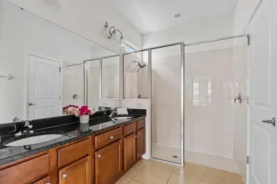 a bathroom with a glass shower and a sink at Ground Floor Gathering up to 9 guests BL387 in Kissimmee