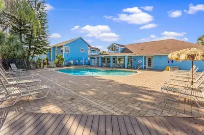 a house with a swimming pool and chairs at Enjoy Disney 3BRs at Villas of Somerset VS2745 in Kissimmee