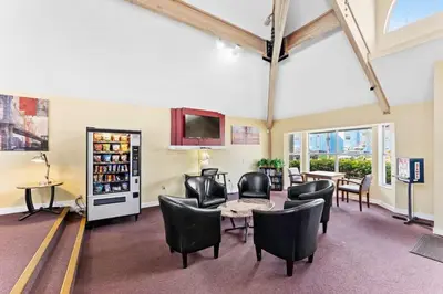 a room with chairs and a table and a tv at Enjoy Disney 3BRs at Villas of Somerset VS2745 in Kissimmee
