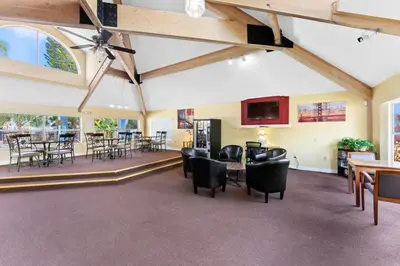 a large room with chairs and tables and a ceiling with beams at Enjoy Disney 3BRs at Villas of Somerset VS2745 in Kissimmee