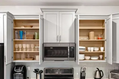 a kitchen with white cabinets and a microwave at Luxury Decor 6BR at Storey Lake sleeps 16 SL2945 in Kissimmee