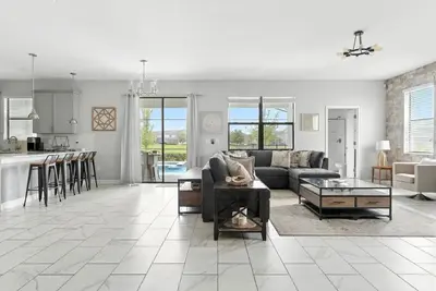 a living room with a couch and a table at Luxury Decor 6BR at Storey Lake sleeps 16 SL2945 in Kissimmee