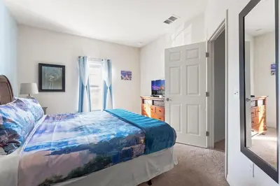 a bedroom with a bed and a window and a mirror at 4BR Community pool across the street WL8989 in Kissimmee
