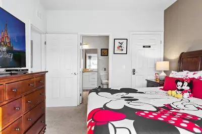 a bedroom with a bed with a mickey mouse blanket at 4BR Community pool across the street WL8989 in Kissimmee