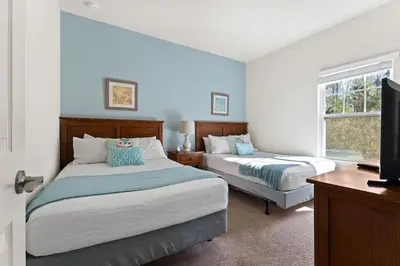 a bedroom with two beds and a flat screen tv at Cozy Decor 4BR at West Lucaya Resort WL8972 in Kissimmee