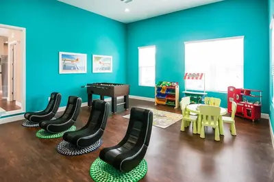 a play room with chairs and a table and a piano at Cozy Decor 4BR at West Lucaya Resort WL8972 in Kissimmee