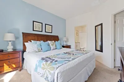 a bedroom with a large bed with a wooden headboard at Cozy Decor 4BR at West Lucaya Resort WL8972 in Kissimmee