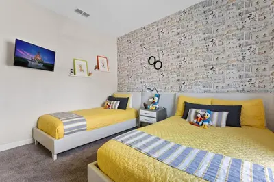 a bedroom with two beds and a brick wall at Disney Familly Lovers up to 11 SL4928 in Kissimmee