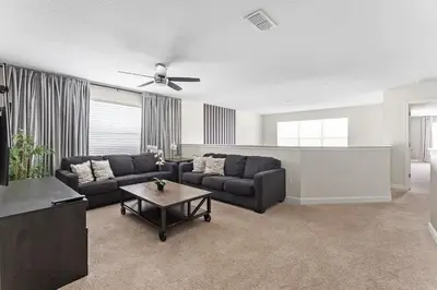 a living room with a couch and a table at 5BR Themed Bedrooms at Storey Lake SL4702 in Kissimmee