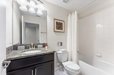 a bathroom with a sink and a toilet and a mirror at 5BR Themed Bedrooms at Storey Lake SL4702 in Kissimmee