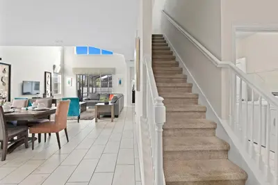 a staircase leading to a living room and a dining room at 5BR Themed Bedrooms at Storey Lake SL4702 in Kissimmee