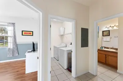 a white bathroom with a sink and a toilet at 4BR Townhome with Lake View – BL481 in Kissimmee