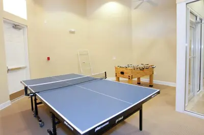 a ping pong table in a room with a table at 4BR Townhome with Lake View – BL481 in Kissimmee