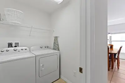 a white kitchen with a stove and a dishwasher at Ground floor spacious house 4BR VP2512 in Kissimmee