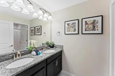 a bathroom with two sinks and a large mirror at 4 BR Bright Cozy at Storey Lake SL3113 in Kissimmee