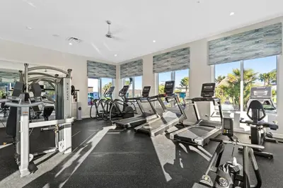 a gym with several treadmills and cardio machines at 4 BR Bright Cozy at Storey Lake SL3113 in Kissimmee