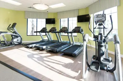 a gym with several tread machines in a room at 2 BR Modern Apt near Disney SL4741 in Kissimmee