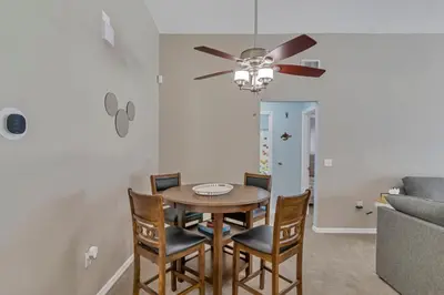 a dining room with a table and chairs and a couch at Disney Themed House Free Heated Pool close Disney 5br 9bd in Orlando