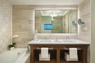 a bathroom with a sink and a tub and a mirror at Four Seasons Resort Orlando at Walt Disney World Resort in Orlando