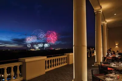 a restaurant with a view of fireworks at night at Four Seasons Resort Orlando at Walt Disney World Resort in Orlando