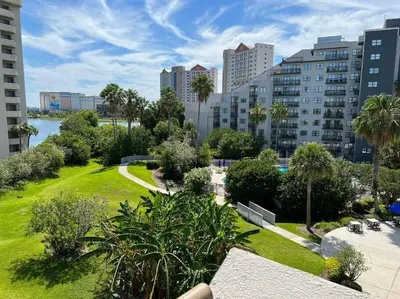 a park with palm trees and buildings in a city at Studio near Universal Studios with great view in Orlando