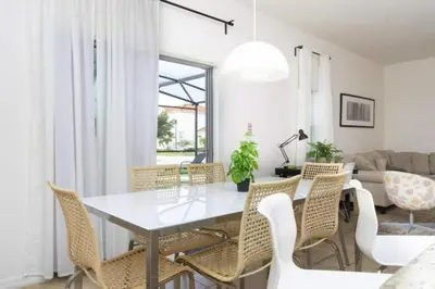 a dining room with a white table and chairs at 4572 Perfect home for your family close to all parks in Kissimmee