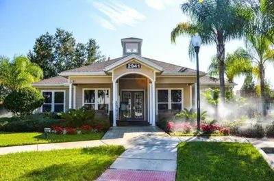 a house with a palm tree in front of it at 5372 Lovely home inside Disney area in Kissimmee