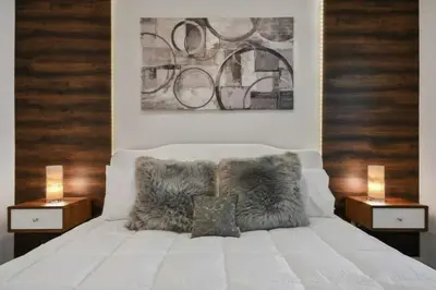 a bedroom with a white bed with two night stands at 3120 BRAND NEW stunning apartment in Kissimmee