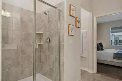 a bathroom with a shower with a glass door at 3120 BRAND NEW stunning apartment in Kissimmee