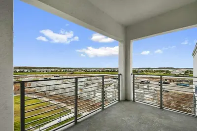 a room with a balcony with a view at 3120 BRAND NEW stunning apartment in Kissimmee