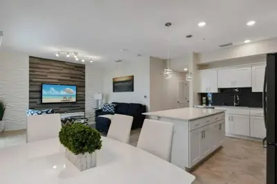 a kitchen and living room with white cabinets at 3120 BRAND NEW stunning apartment in Kissimmee