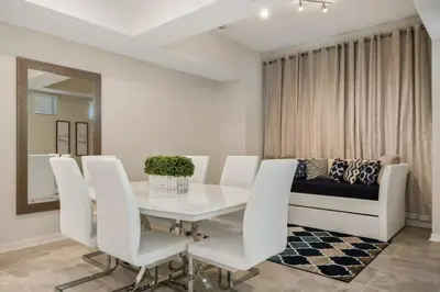 a dining room with a white table and white chairs at 3120 BRAND NEW stunning apartment in Kissimmee