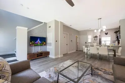 a living room with a couch and a dining room at 8553 Stunning house close to Animal Kingdom in Kissimmee