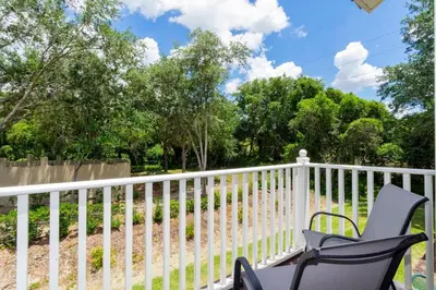 a white fence with a chair on a porch at 8553 Stunning house close to Animal Kingdom in Kissimmee