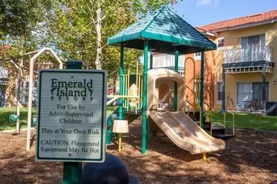 a park with a playground with a slide and a sign at 8553 Stunning house close to Animal Kingdom in Kissimmee