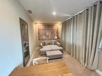 a bedroom with a bed and a table and a mirror at Home in Orlando 7 Min from Disney Parks and 20 from Universal - Sleeps 8! 4 bedrooms each with a private bathroom in Orlando