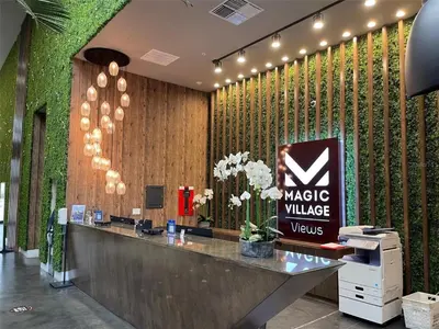 a cashier counter in a lobby with a wall of plants at Home in Orlando 7 Min from Disney Parks and 20 from Universal - Sleeps 8! 4 bedrooms each with a private bathroom in Orlando