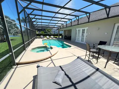 a patio with a swimming pool with a pergola at Mickeys Escape - Magical Lakeview 7BR - 4 Master Suites Pool & Hot Tub BBQ Home Theater and 2 Miles Disney! in Orlando