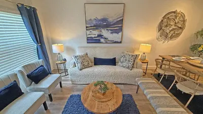 a living room with a couch and a table at Villas at Seven Dwarfs Resort - Near to Disney in Kissimmee