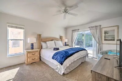 a bedroom with a bed and a ceiling fan at Pool and Lanai Emerald Isle Resort Home! in Kissimmee
