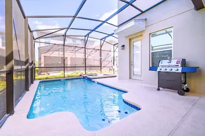 a swimming pool in the middle of a house at Bright & Airy 5BR Resort Home with Pool in Kissimmee