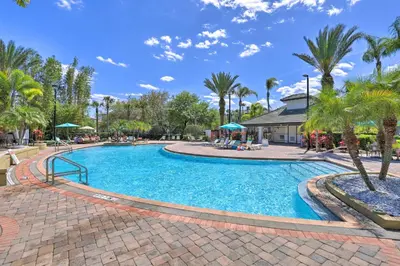a pool at a resort with palm trees at Vista Cay Resort Condo about 5 Mi to Universal! in Orlando
