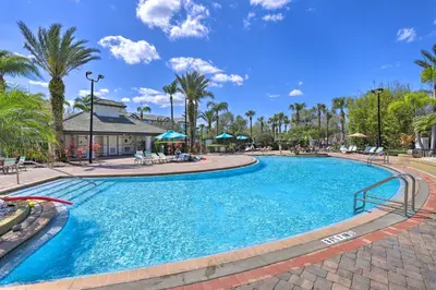 a swimming pool at a resort with palm trees at Vista Cay Resort Condo about 5 Mi to Universal! in Orlando