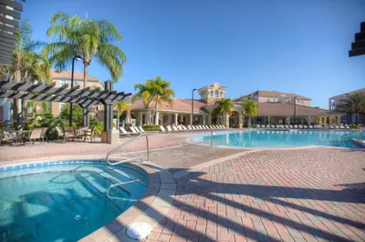 a swimming pool with palm trees and a resort at 4814 Cayview Avenue #401 in Orlando