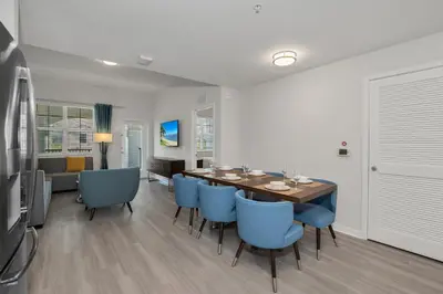 a dining room with a table and blue chairs at Newly Renovated Condo wFREE Resort Access in Orlando
