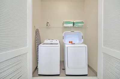 a kitchen with a washer and dryer in a room at 2914 Salted Rim Road in Orlando