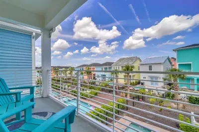 a balcony with two blue chairs and condos at 2914 Salted Rim Road in Orlando