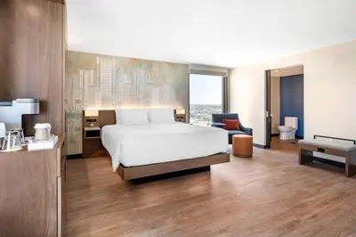 a hotel room with a bed and a bathroom at Cambria Hotel Orlando near Universal Theme Parks in Orlando