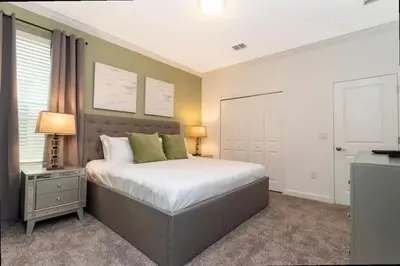 a bedroom with a large bed and two lamps at Stunning Family Friendly 5 Bd w/ Pool Close to Disney @ Storey Lake 4242 in Kissimmee